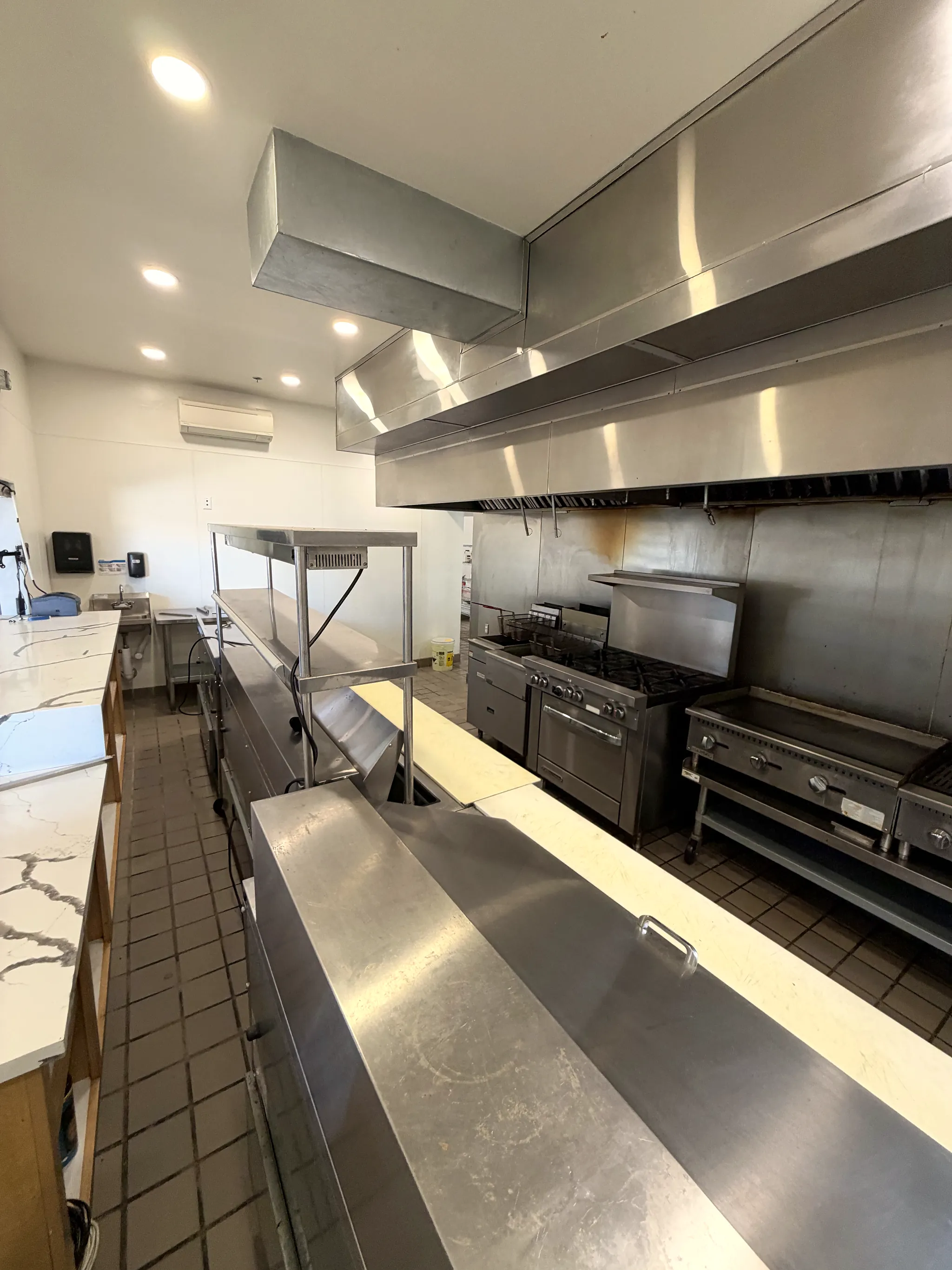 Commercial kitchen hood line with range and griddle