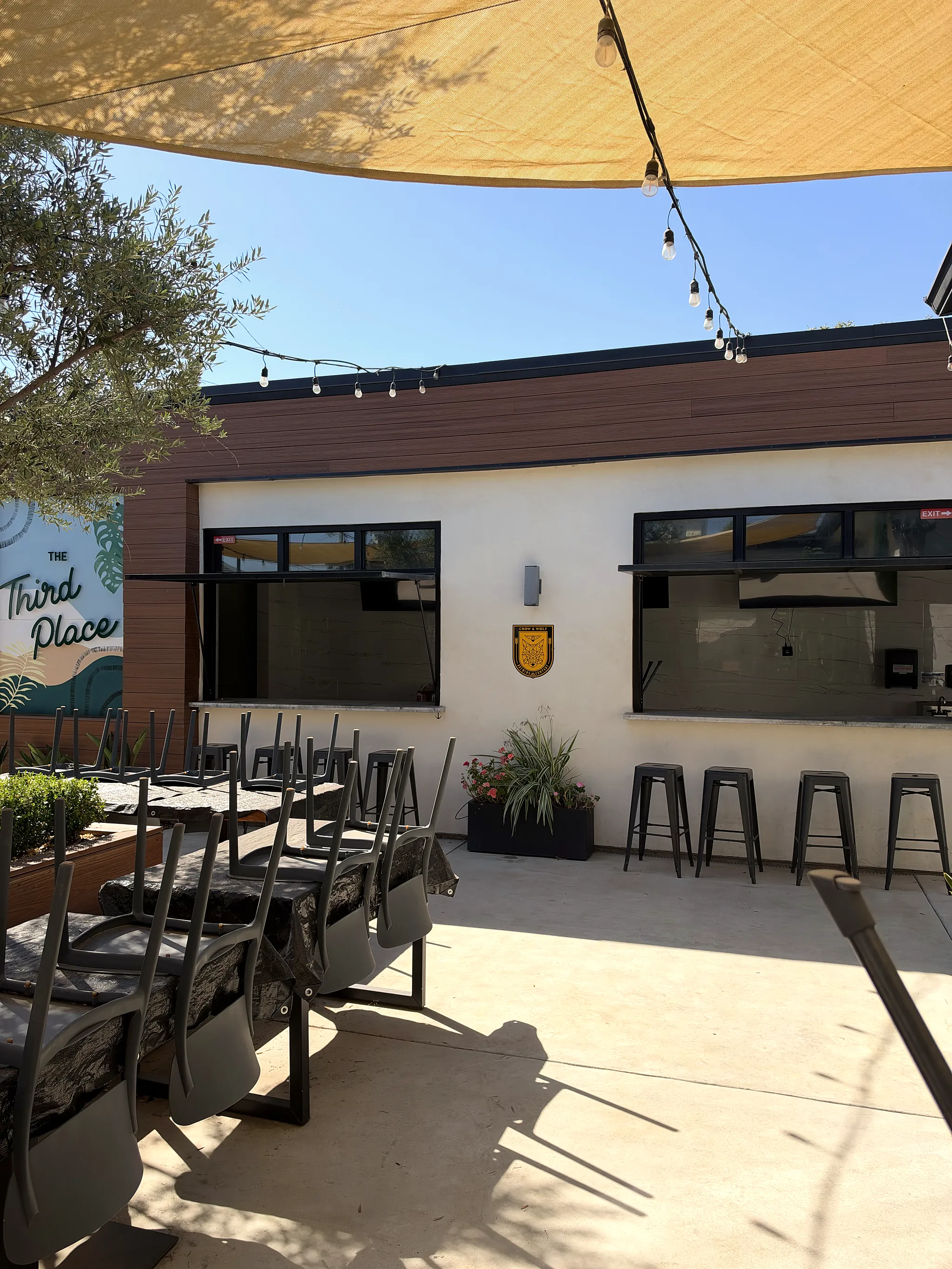 Patio seating along the open bar windows